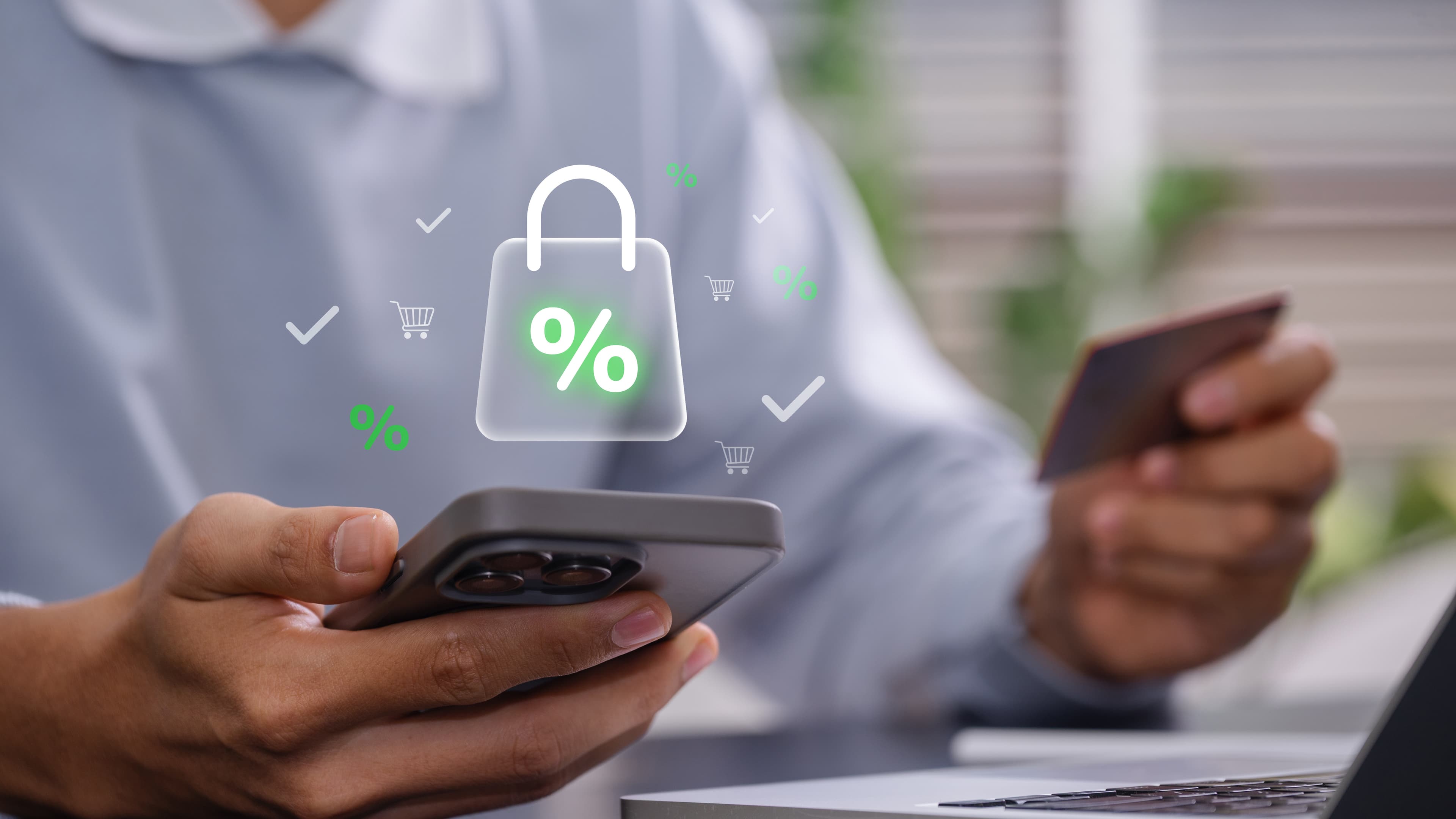 A man holding a credit card and mobile phone with a shopping bag and lock graphic